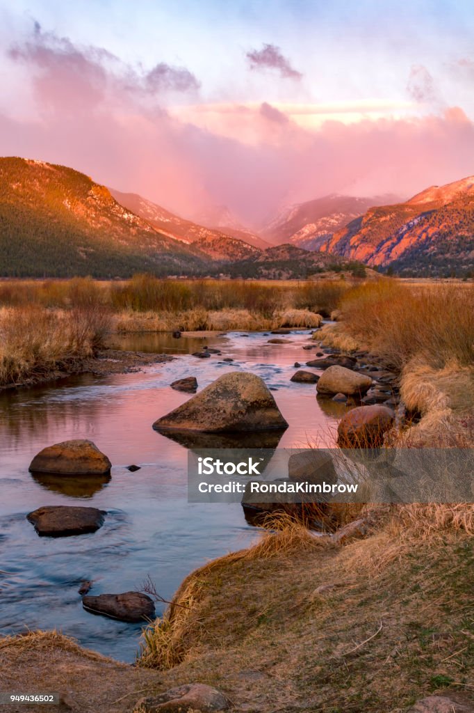 Spring storms over the continental divide with a glowing Big Thompson River flowing at sunrise Colorado Stock Photo