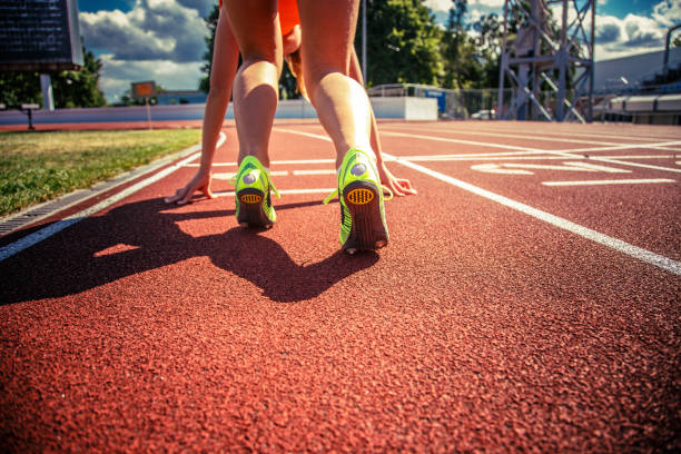 istock Slim girl on the stadium track. 949438346