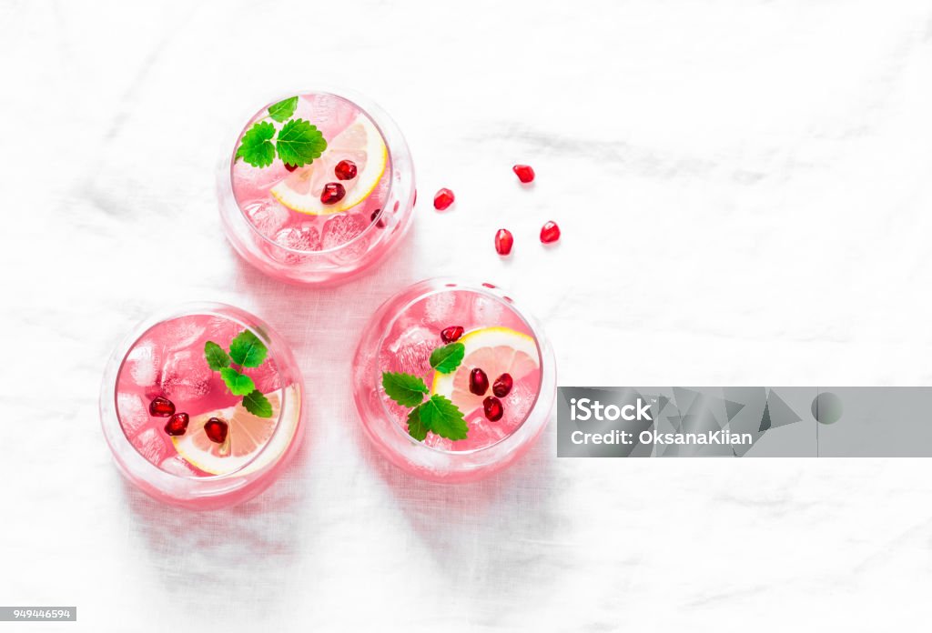Pomegranate tequila cocktail. Summer light alcoholic drink,  cooling aperitif. On light background, top view, free space. Flat lay Cocktail Stock Photo
