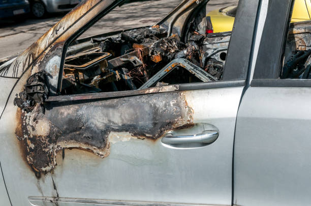 istock Total damage on new expensive burned car in fire on the parking lot, selective focus close up 949450686