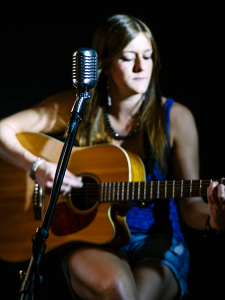 istock Blurred guitarist behind vintage microphone 949454124