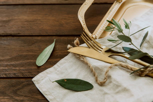 istock Rustic Wedding. Decorated table with gold vintage cutlery. 949454224