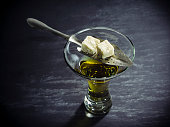 Glass of Absinthe with sugar cubes and spoon