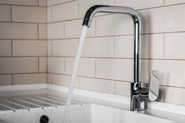 istock water flows from the tap into the sink 949463140