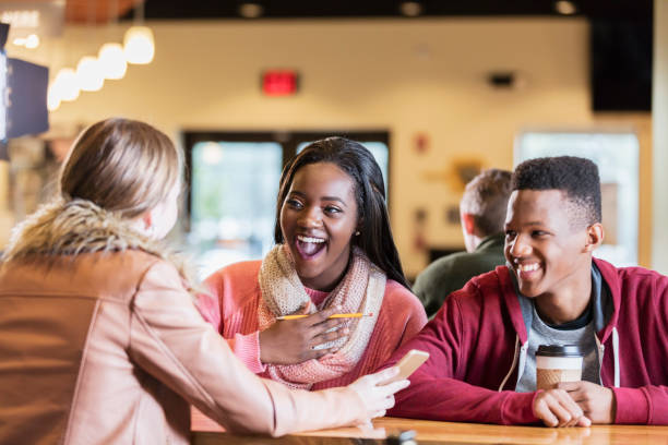 istock Multi-ethnic teens hanging out in coffee shop 949464328