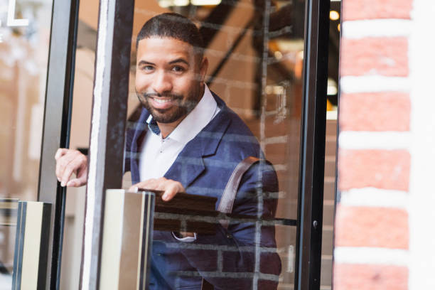 Mixed race man opening exterior door, leaving work