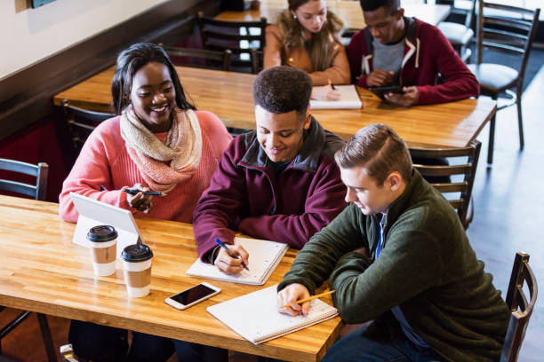 istock Teenagers studying together in coffee shop 949467100