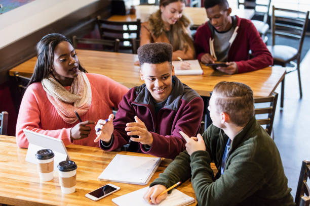 istock Teenagers studying together in coffee shop 949467104
