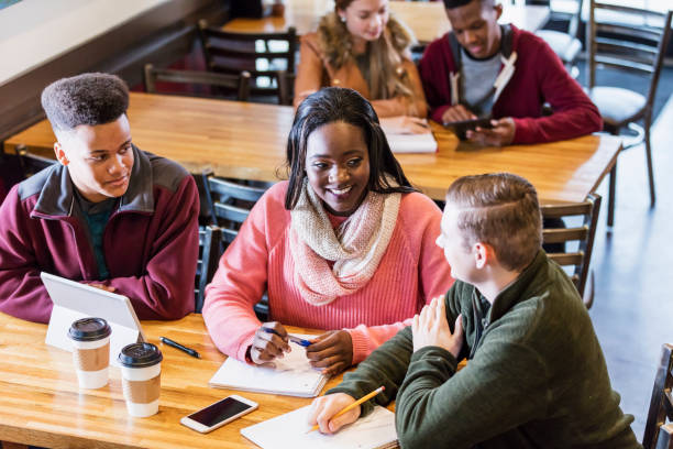 istock Teenagers studying together in coffee shop 949467356