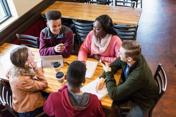 istock Teenagers studying together in coffee shop 949467358