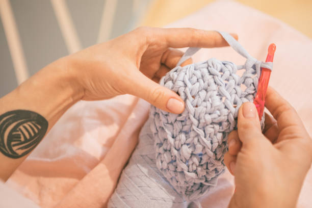 istock Handmade process. woman hands knitting crochet. hobby crafts things. Horizontal composition 949470670