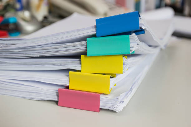 istock Stack of papers documents in archives files with paper clips on desk at offices 949475318