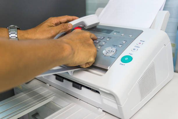 istock Men are using a fax machine in the office. Business concept 949475354