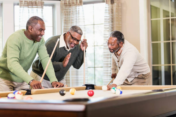istock Three African-American men playing billiards 949475844