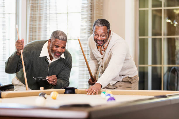 istock Two African-American men playing billiards 949475852