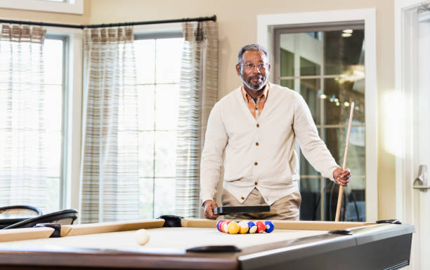 istock Mature African-American man shooting pool 949475962