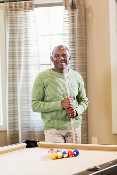 istock Mature African-American man shooting pool 949475966