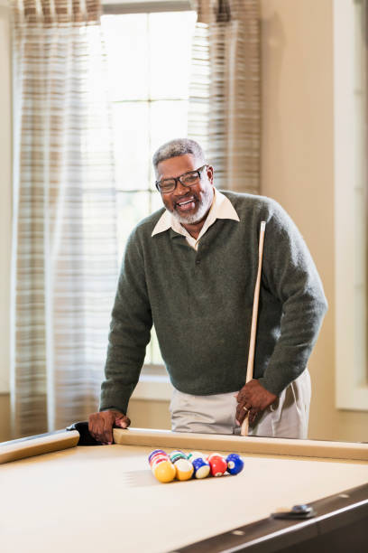 istock Senior African-American man shooting pool 949476088