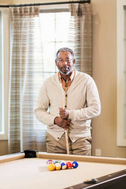 istock Mature African-American man shooting pool 949476196