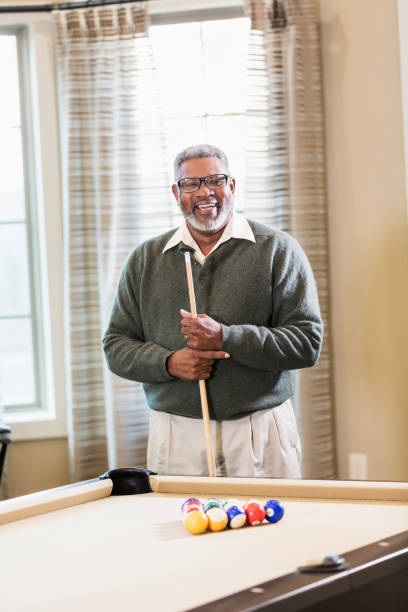 istock Senior African-American man shooting pool 949476472