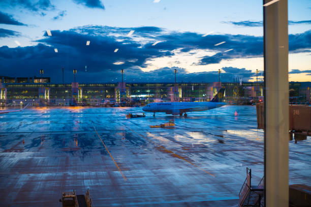 Munich, Germany - September 12, 2017: Munich airport. Large windows showing tarmac,  planes and terminal. It's the blue hour.