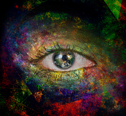 Surrealism. Woman's eye with galaxies. Earth map credit NASA https://visibleearth.nasa.gov/view.php?id=73909