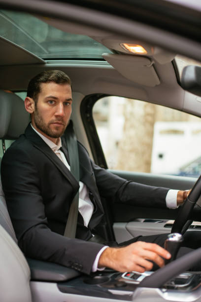 istock Businessman driving car 949480328