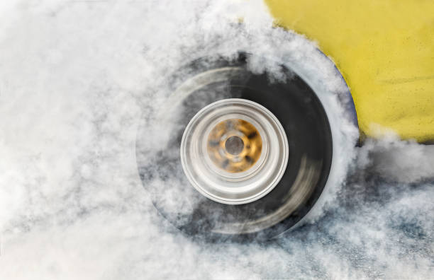 istock Drag racing car burn tire at start line 949480786