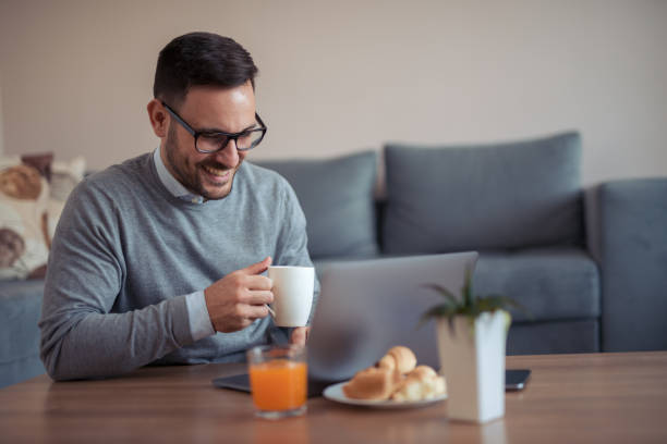 istock Happy young couple sitting on the sofa at home 949482134
