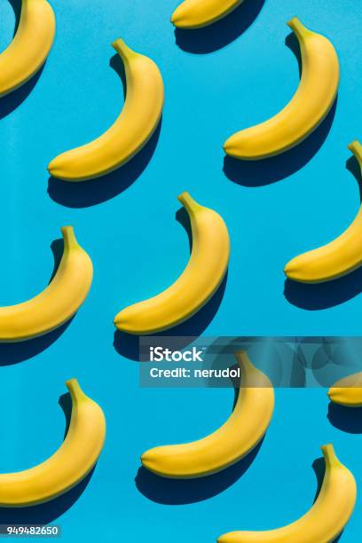 Background With Bright Bananas On Blue Stock Photo - Download Image Now - Repetition, Food, Banana