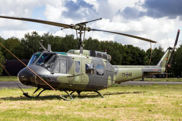 Bell UH-1 Huey helicopter BEAUVECHAIN, BELGIUM - MAY 20, 2015: German Army Bell UH-1 Huey helicopter sitting idle on Beavechain airbase. uh 1 helicopter stock pictures, royalty-free photos & images