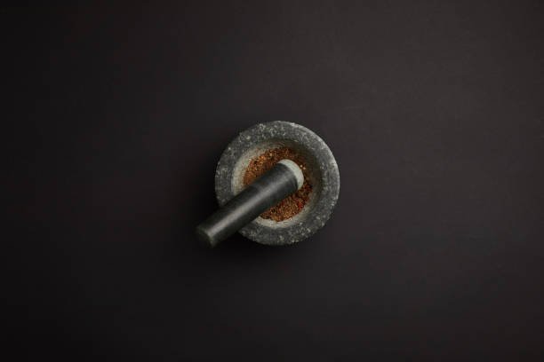 istock flat lay with mortar and pestle on black tabletop 949494812