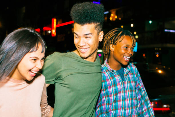istock Three young friends walking through the city together at night. 949495582