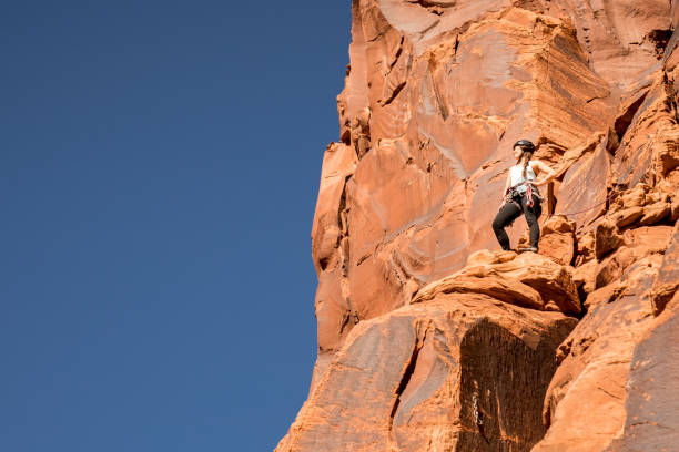istock Female Rock Climber at the Summit 949504714