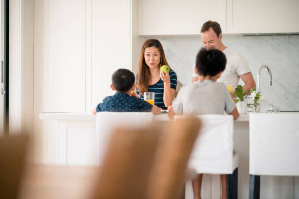 Family preparing breakfast Family preparing breakfast. Family eating together breakfast. brolga stock pictures, royalty-free photos & images