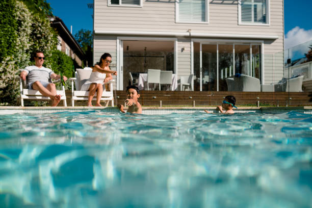 istock Family having fun in the pool 949508642