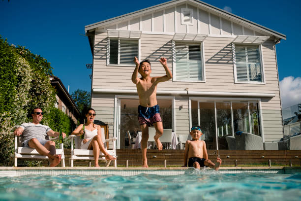 istock Family having fun in the pool 949508690