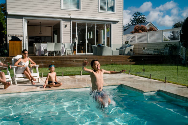 istock Family having fun in the pool 949508844