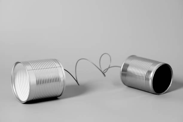 Tin can phone. Communication concept . Tin can phone on gray. Communication concept . string telephone stock pictures, royalty-free photos & images