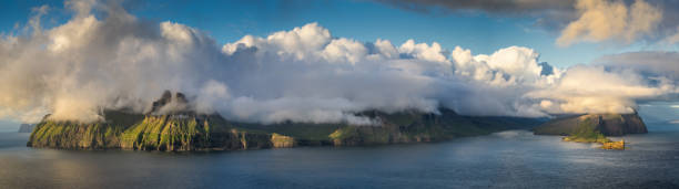 Vagar under clouds Vagar and Tindholmur islands under big cloud in sunset, Faroe Islands mykines faroe islands photos stock pictures, royalty-free photos & images