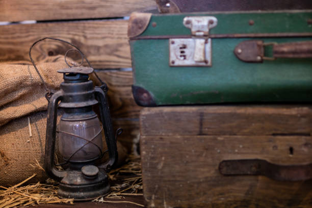 istock Oil lamp and old suitcase. Light source in an old room. Stylized interior. 949520112