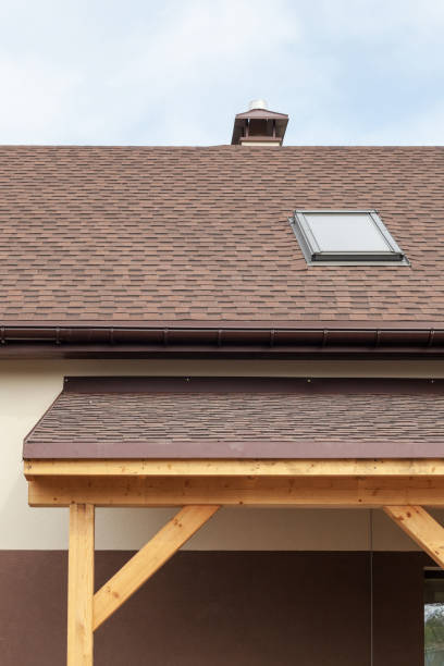 istock Window skylight on a roof with asphalt shingles or bitumen tiles under construction. 949526362