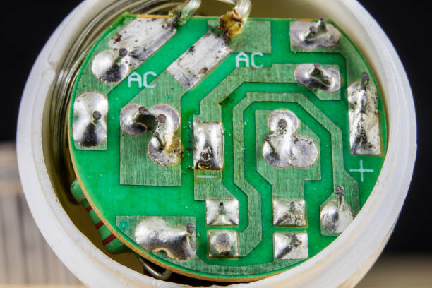 istock Electronics in high magnification. Resistors and diodes are soldered to an electronic board. Dark background. 949528814
