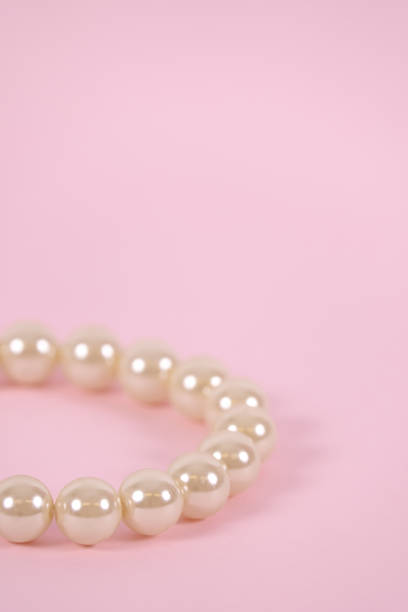 istock Pearl bracelet on pink 949536422