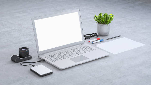 istock Laptop on a desk with accessories, blank screen mock-up isometric 949541612