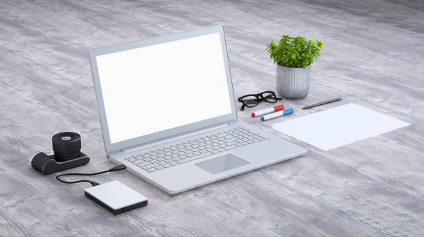 istock Laptop on a desk with accessories, blank screen mock-up isometric 949541628