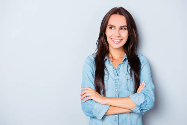 istock Attractive brunette with crossed hands isolated on gray background 949554022