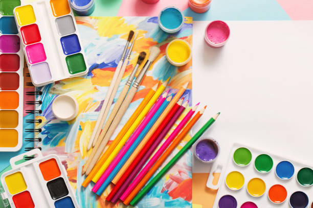 istock paints, pencils and brushes on paper 949561226