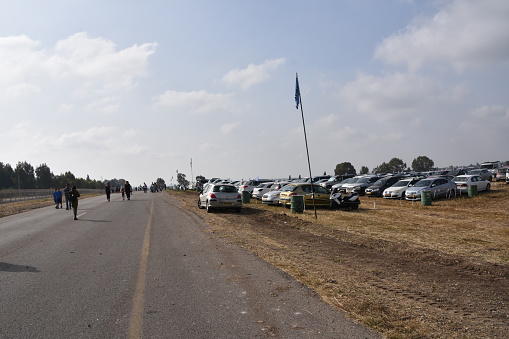 Beit Elazari, Israel , April 19, 2018 : Crowd of people marching to the annual airplane show in Tel Nof, Israel.Every Independence Day there is a free aircraft exhibition open to the general public. In the photo you can see people, families and children walking towards the aircraft exhibition.The picture was taken on the way to the exhibition, which takes place at the Tel Nof Air Force Base near Beit Elazari