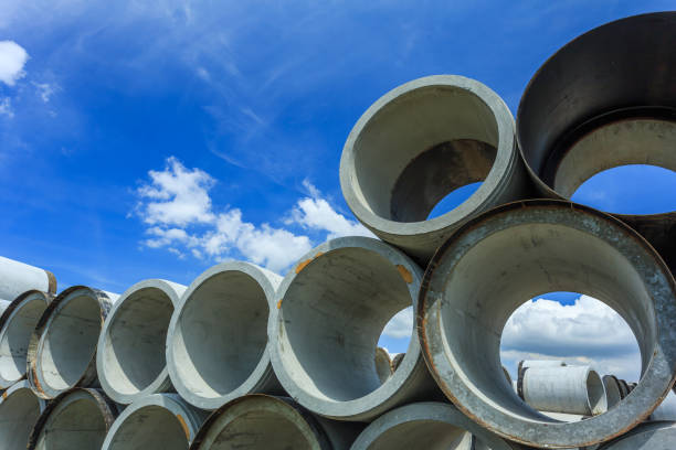 istock Stack of concrete drainage pipes for wells and water discharges 949564796